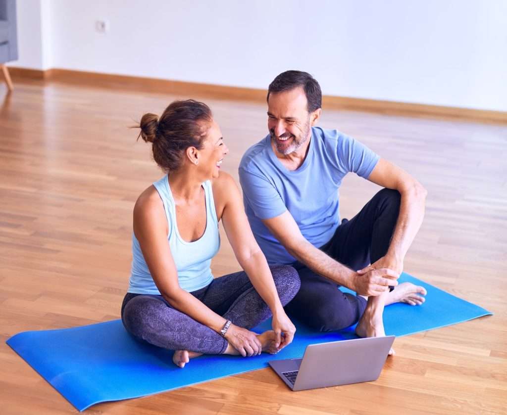 Man and woman are sitting on the floor, talking and smiling