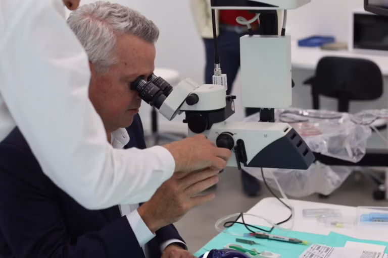 Jim Hollingshead CEO of BVI medical tests a microscope at the BVI Experience Hub during a hands on training session