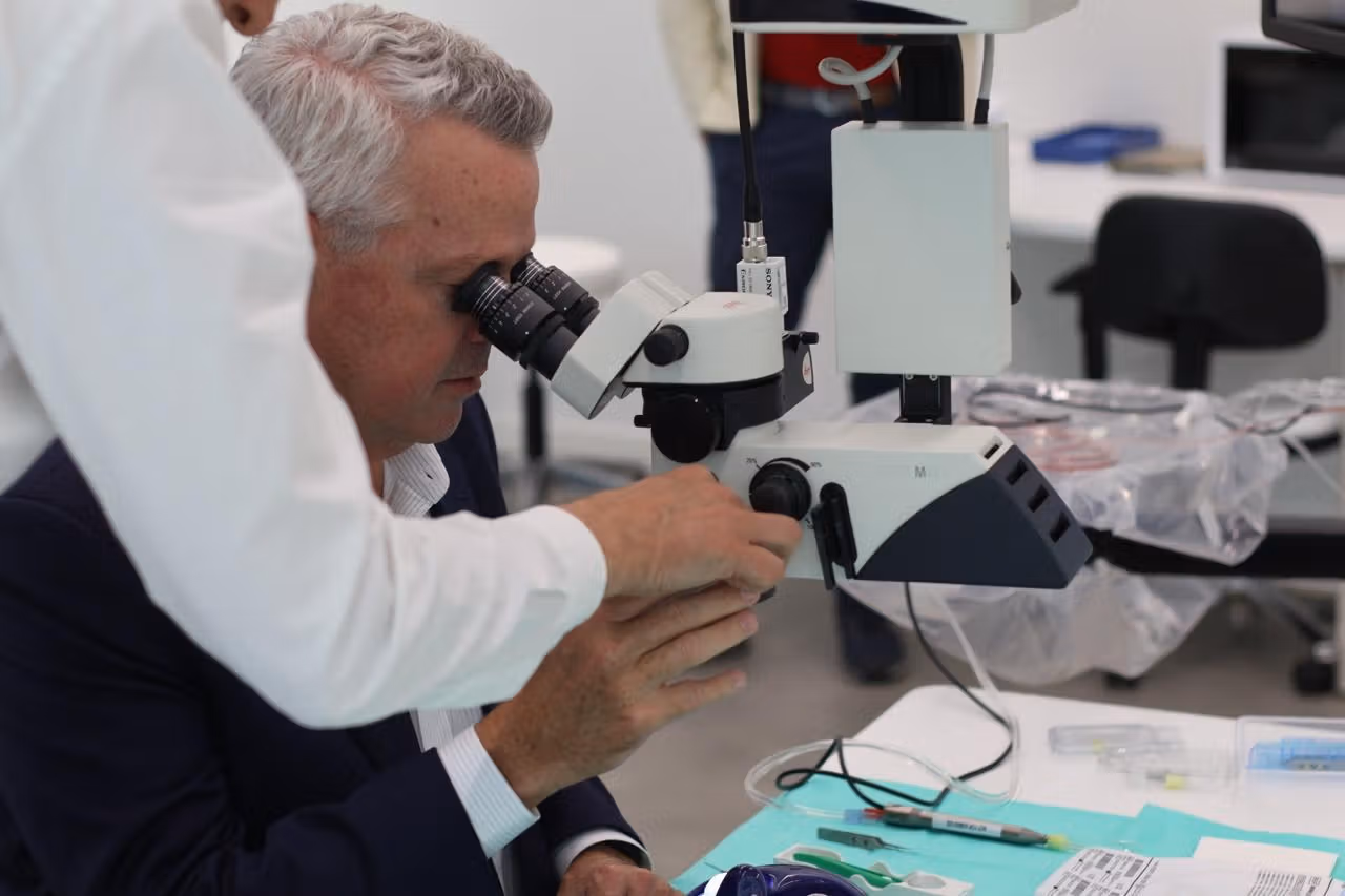 Jim Hollingshead CEO of BVI medical tests a microscope at the BVI Experience Hub during a hands on training session